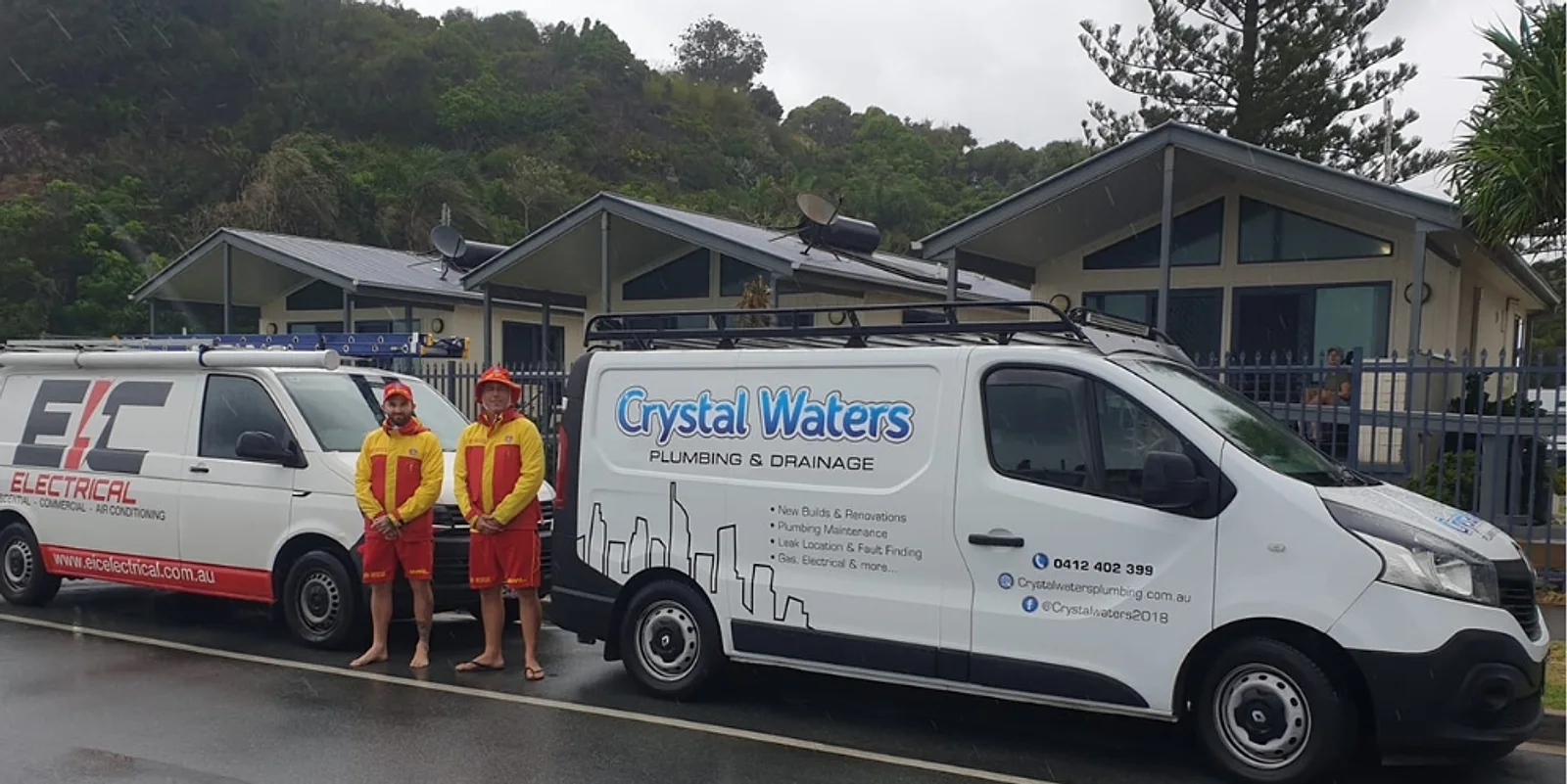 The Crystal Waters team in surf lifesaving kit beside the Crystal Waters and EIC Electrical vans