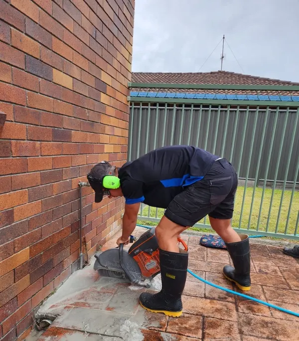 Chasing out a wall to reach a leaking pipe